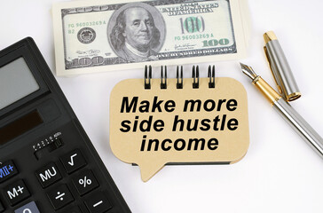 On a white surface, a calculator, dollars, a pen and a sign with the inscription - Make more side...