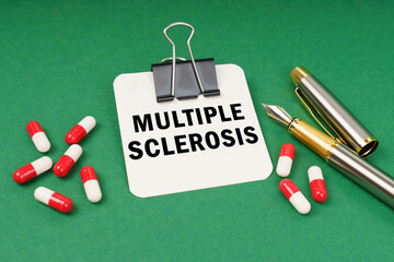 On the green surface of the tablet, a pen and a notepad with the inscription - Multiple Sclerosis