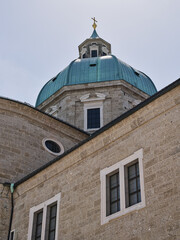 Fototapeta premium Rear tower with cross of Cathedral of Saints Rupert and Vergilius in Salzburg, Austria