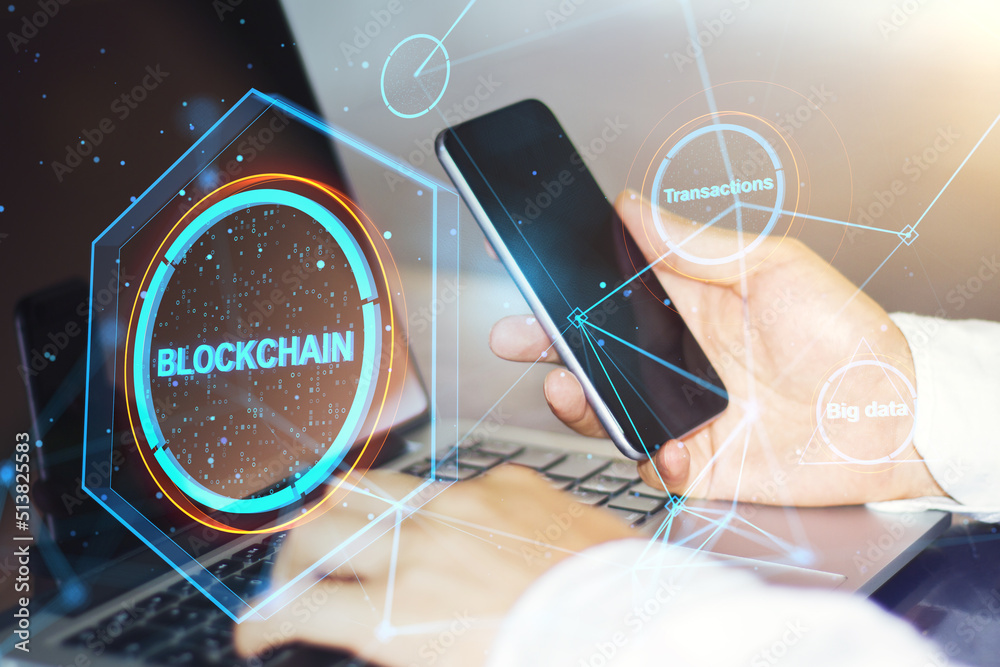 Poster Close up of hands using laptop keyboard and smartphone on desktop with creative polygonal blockchain hologram and blurry outdoor background. Technology and fintech concept. Double exposure.
