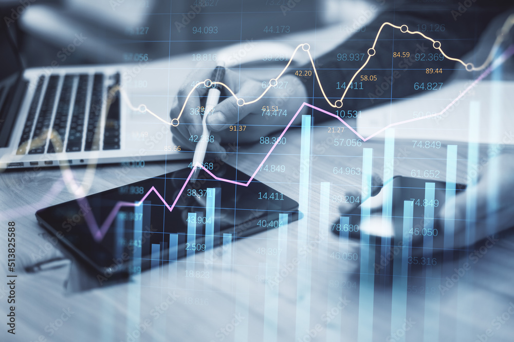 Poster businessman hand using tablet, smartphone and laptop at desktop with abstract glowing business chart
