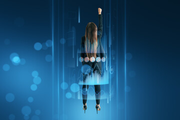 Back view of businesswoman flying upward surrounded with business chart hologram on blurry blue...