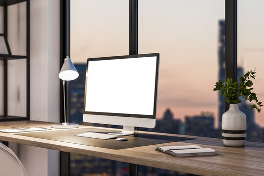 Perspective view on blank white modern computer monitor with place for your logo or text on stylish wooden table on panoramic window background with night city view. 3D rendering, mockup