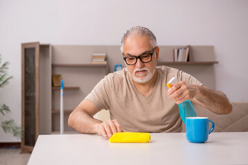 Old man doing housework at home