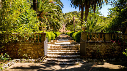 Entrance gate of the botanical garden Jardines de Alfabia nearby Bunyola at Mallorca with a long...