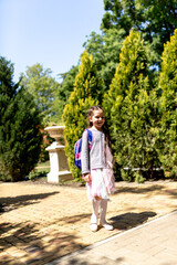 Back to school. Cute child girl with backpack running and going to school with fun