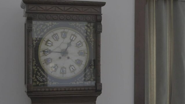 Pendulum from old pendulum clock in motion - glass door opened
