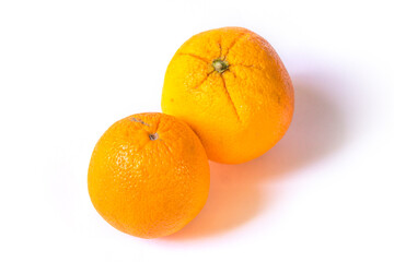 two oranges lie on a white background