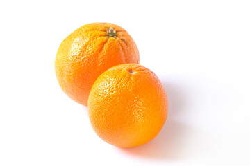 two oranges lie on a white background