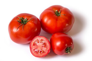 red tomatoes lie on a white background