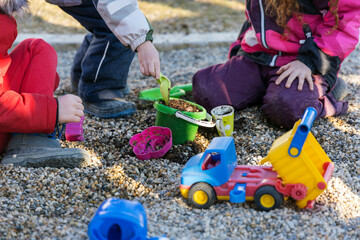 Children are playing with a truck in stones. High quality photo