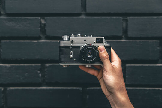 Close-up, vintage film retro camera in male hands.