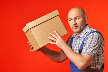 Bald, male courier who was carrying a parcel in a cardboard box was very surprised, because...