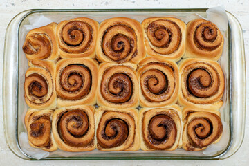 Homemade sweet cinnamon rolls. Freshly cooked buns in a dish. View from above