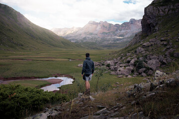 Hiker traveller man in front of a mountain in Pyrenees, Spain, Aguas Tuertas