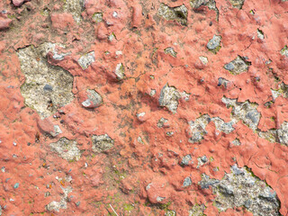 Old uneven surface. The paint is falling off. Stone wall.