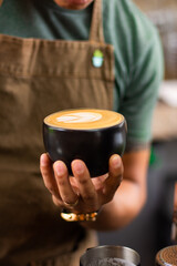 Unrecognizable man with a Cappuccino latte coffee art