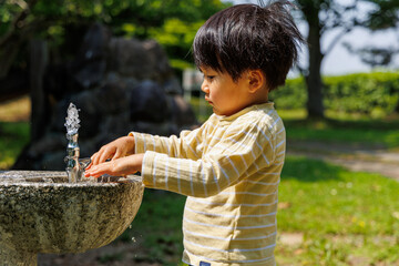 水道で手を洗う子供
