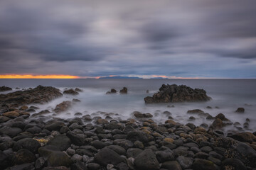 Fototapeta na wymiar Sunrise on Reis Magos beach. Canico, Madeira, Portugal. October 2021. Long exposure picture