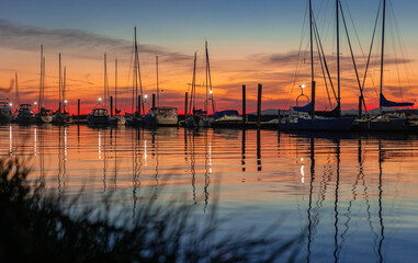 Beautiful sunset at the yacht harbor. Summer sunset at the sea.