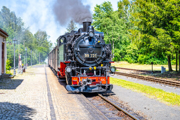 Fototapeta na wymiar Old steam locomotive on narrow-gauge railwaytrack