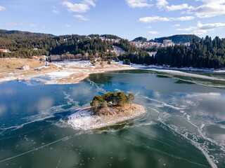 Aerial winter view of Dospat Reservoir covered with ice, Bulgaria