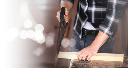 Carpenter working on woodworking machines in carpentry shop. he works in a carpentry shop or warehouse