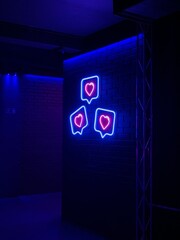 Photo of three neon hearts in a nightclub
