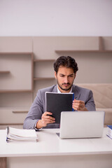 Young male employee working from home during pandemic