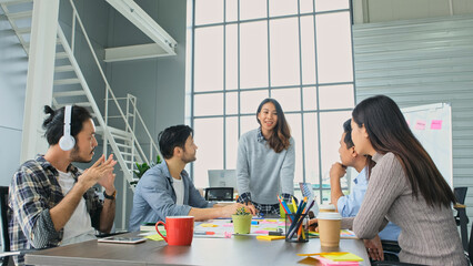 Businesswoman presenting business plan information to team at office meeting, Creative asian woman...