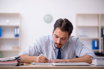 Young male employee working in the office