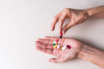 hand popping a pill, pandemic, health and wellness concept