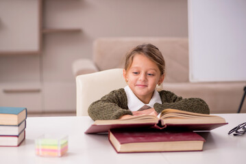 Young little girl studying at home