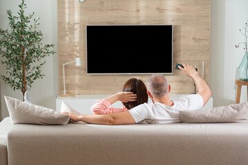 man trying to turn on tv adult couple in love in living room