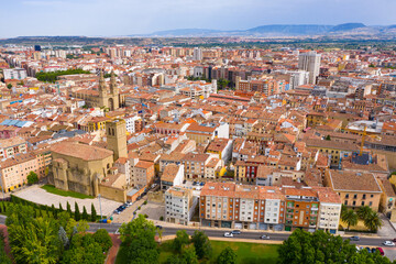 Fototapeta na wymiar Aerial view of Logrono cityscape on banks of Ebro river overlooking spires of Co-cathedral of Santa Maria in summer day, Spain..