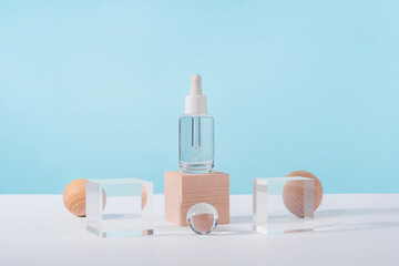 Serum cosmetic bottle with peptides and retinol on acrylic and wooden blocks on pink background....