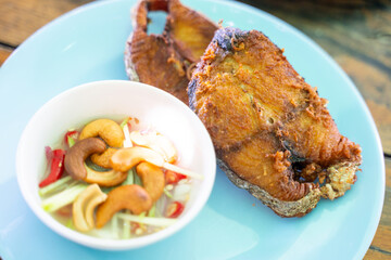 Fried fish with fish sauce serve with salad