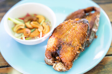 Fried fish with fish sauce serve with salad