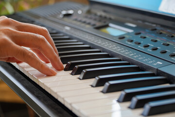 male hands playing the piano .Human hands playing the piano on the party . Man playing the...