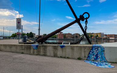 Beutiful buildings reflection on Ravenna's darsena on a morning sunny day . a dock is an enclosed...