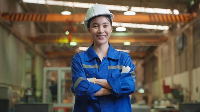 Portrait of Asian female industry worker working in factory warehouse.	
