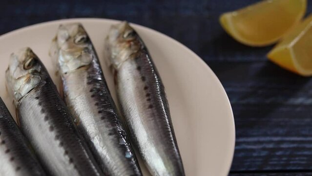 Rotating saltwater fish sardine on the table