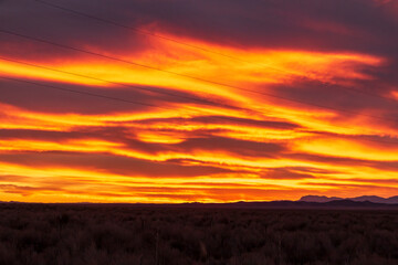 red ,fiery dramatic sky during sunset in New Mexico .