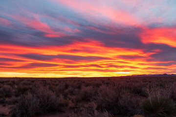 red ,fiery dramatic sky during sunset in New Mexico .