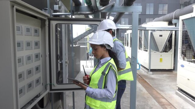 Engineer under checking the industry chilled water fan coil unit air conditioner is water cooling tower air chiller HVAC system of large industrial building to control air system 