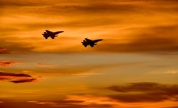 Silhouette airplane with beautiful colorful sunset sky background.

