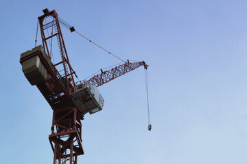 Naklejka premium construction of buildings and a crane on blue sky background