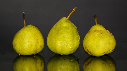 Fototapeta na wymiar three pears on a black background