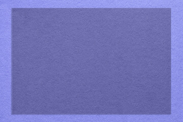 Texture of craft violet color paper background with lavender border, macro. Structure of kraft very peri cardboard