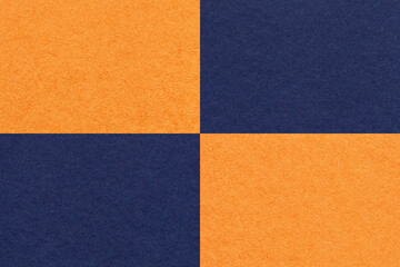 Texture of craft navy blue and orange paper background with cells pattern, macro. Structure of vintage kraft cardboard.